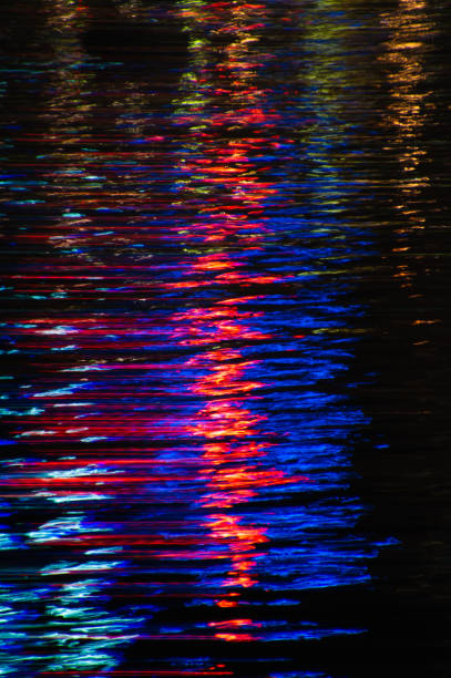 istock Colourful lights are reflected in moving water at night to create abstract paint stroke like effects 1282505763