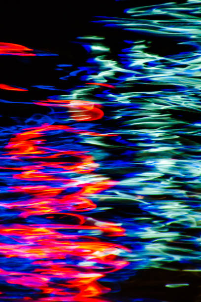 istock Colourful lights are reflected in moving water at night to create abstract paint stroke like effects 1282505873