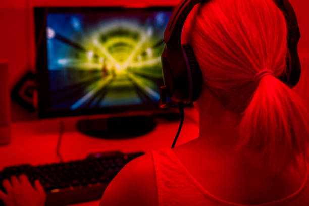 istock rear view of a young woman playing computer games 1282507719