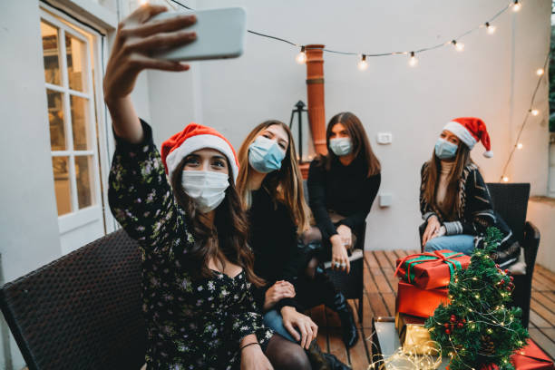 istock Four friends celebrating Christmas together, taking a selfie 1282509573