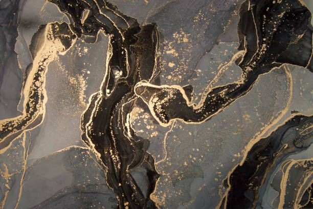 High resolution. Luxury abstract fluid art painting in alcohol ink technique, black, gray and gold paints. Imitation of marble stone cut, glowing golden veins. Mysterious and dreamy design. marble rock stock illustrations