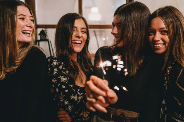 istock Four friends celebrating together with sparklers 1282510047