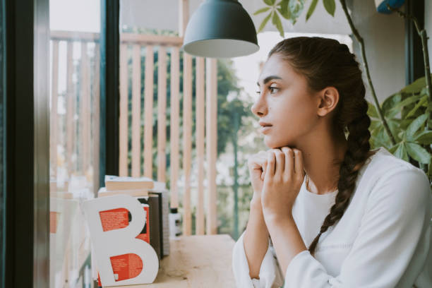 istock Beautiful woman is drinking coffee in cafe. 1282510913
