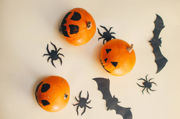istock Halloween decoration pumkins on yellow background 1282511834