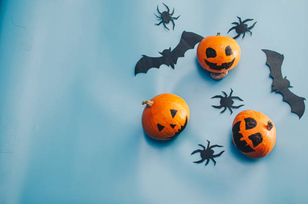 istock Halloween decoration pumkins on blue background 1282511995