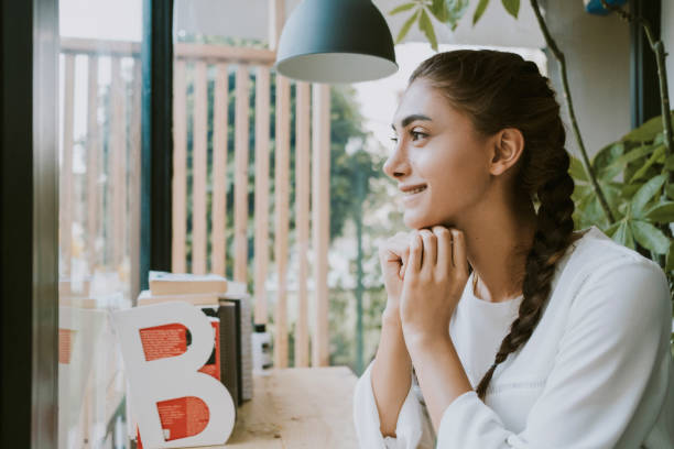 istock Beautiful woman is drinking coffee in cafe. 1282513762
