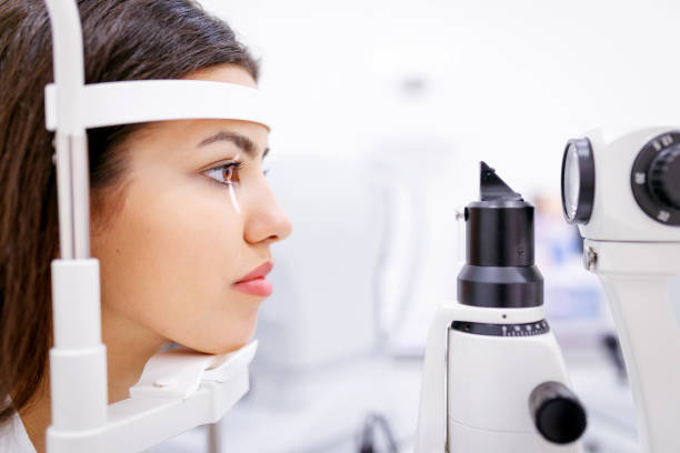 istock Young woman checking eyesight on ophthalmic refractor 1282515140