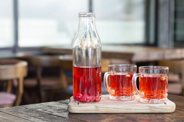 istock Berry kombucha drink and glass cups on wood table 1282516773