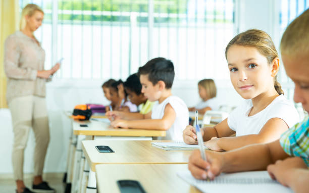 istock Cheerful preteen girl during lesson in elementary school 1282516929
