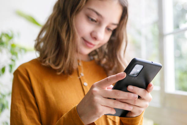istock young girl at home taking selfie with mobile phone. Z generation concept using technology 1282518269