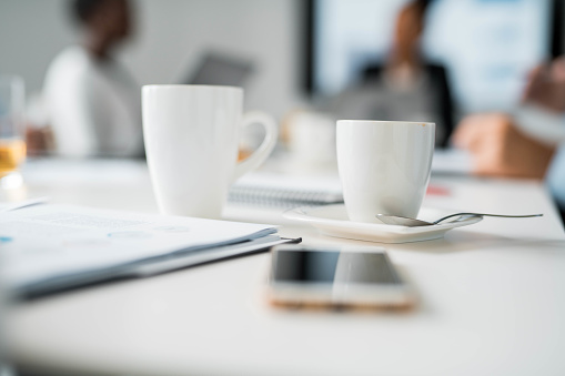 Two Coffee Cups On Conference Table During Business Meeting