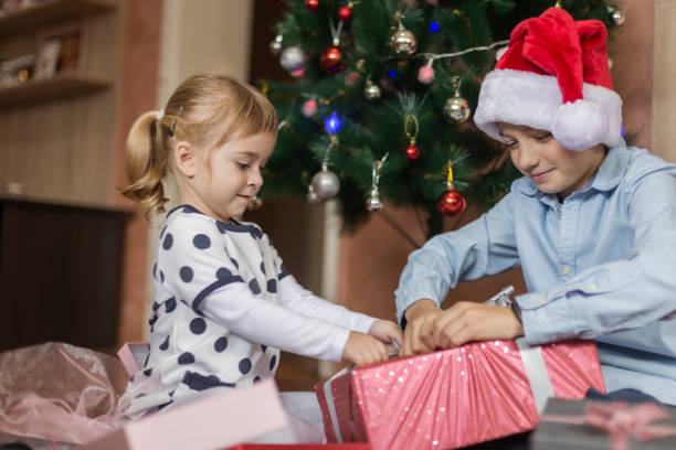 istock Brother and sister opening Christmas gift 1282518833
