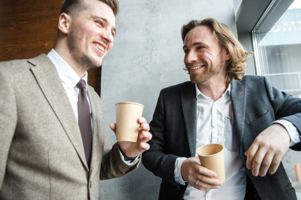 istock Two men are looking at each other and laughing 1282520056