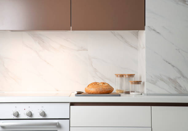 istock White kitchen interior. On a countertop lies a loaf of bread. Minimalism 1282521850