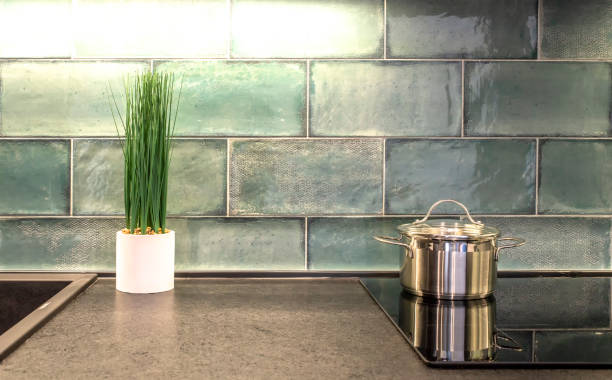istock Kitchen worktop with flowerpot and metal pan in minimal style. 1282521867