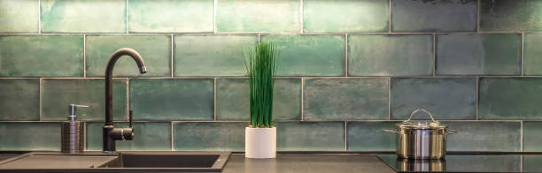 istock Kitchen worktop with flowerpot and metal pan in minimal style. 1282521879