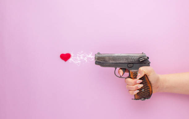 istock Valentine's Day concept. Shooting with heart on pink background. 1282521909