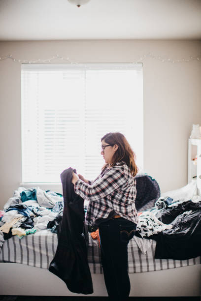 istock Hispanic Woman Folding Laundry at Home 1282523259