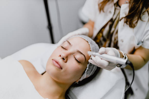 Young woman having a collagen induction therapy Beautiful young woman having a micro-needling collagen facial beauty treatment in the beauty clinic beauty treatments stock pictures, royalty-free photos & images