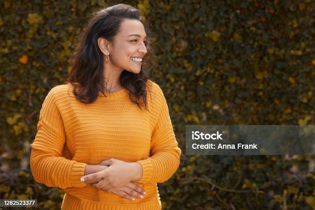 Portrait Of Beautiful Happy Woman In A Yellow Jumper Stock Photo - Download Image Now
