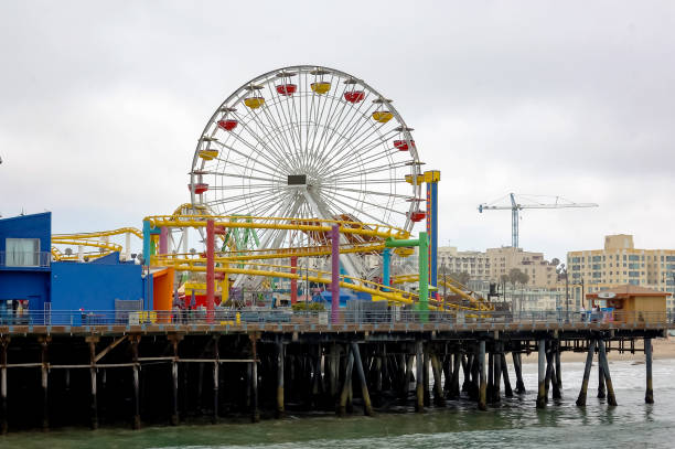 istock Ferris wheel and a roller coaster on a pier in California 1282525937
