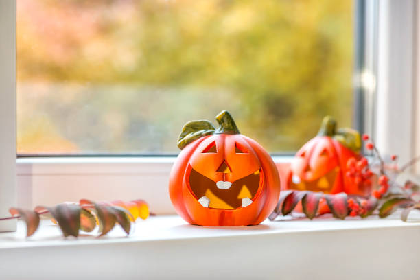 istock Funny decorative pumpkins for Halloween stand on the windowsill. 1282526421