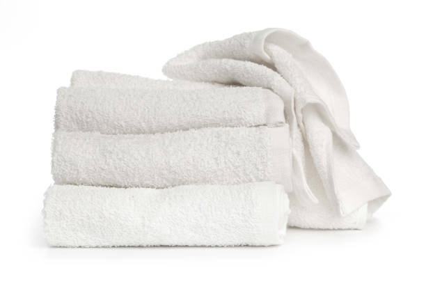 istock several white clean towels rolled up on a white background 1282526541