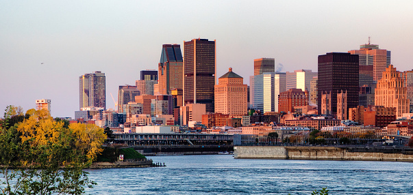 Downtown Montreal skyline at dawn from the Saint Lawrence river on a clear Autumn day.