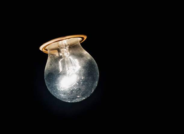 istock round light bulb shines in the darkness 1282528921