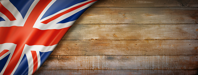 United Kingdom, UK flag on vintage wood wall. Horizontal panoramic banner.