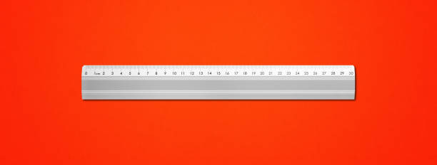 istock Metal ruler isolated on red background 1282529799