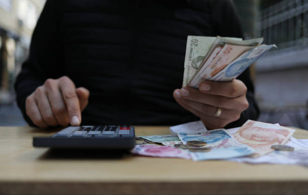 istock man doing financial transactions with calculator holding money 1282530655