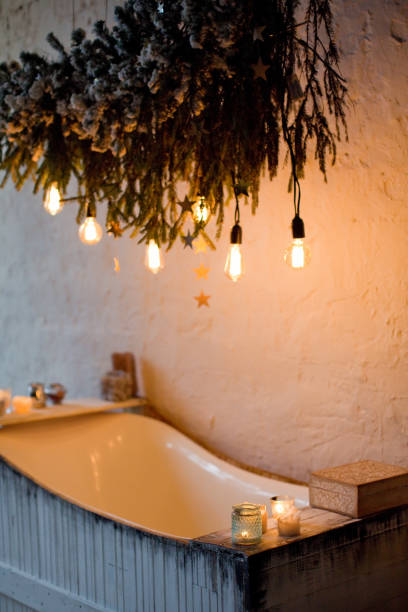 istock Wooden bathtub with candles and lights 1282530909