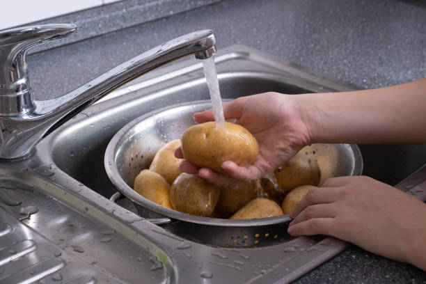 istock the potatoes are washed under running water in a colander in the kitchen 1282531221