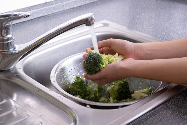 istock in the hands of broccoli washed under running water in the kitchen 1282531243