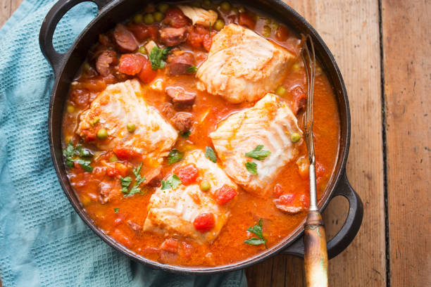 Cod chorizo stew with peas and parsley in tomato sauce Cod chorizo stew with peas and parsley in tomato sauce stew photos stock pictures, royalty-free photos & images