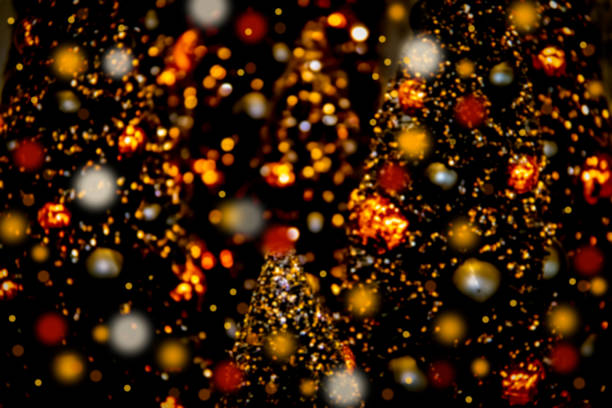 istock Blurred Bokeh Halloween trees background - Black with orange and gold 1282531891