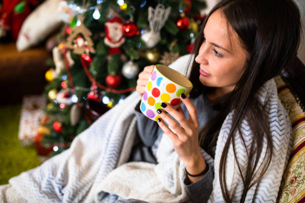 istock A young woman relaxing at home for Christmas 1282532485
