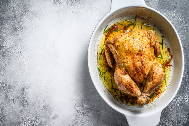 Delicious baked, crispy chicken served on a ceramic dish. White background. Top view. Copy space Delicious baked, crispy chicken served on a ceramic dish. White background. Top view. Copy space. celebrity roast stock pictures, royalty-free photos & images