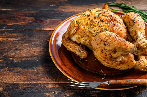 istock Delicious baked chicken on wooden table.  Dark background. Top view. Copy space 1282533146