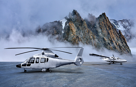 Helicopter and Propeller Airplane on Parking Apron at Snow-capped Mountains Backgrounds