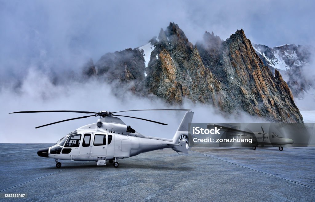 Helicopter and Propeller Airplane on Parking Apron at Snow-capped Mountains Backgrounds Helicopter and propeller airplane on parking apron at snow-capped mountains backgrounds. Helicopter Stock Photo