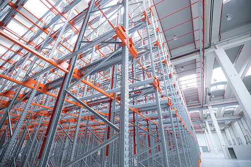 Details of industrial construction in an empty warehouse with empty racks