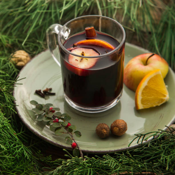 istock Hot mulled wine in a cup with ingredients to cook on plate. 1282538104