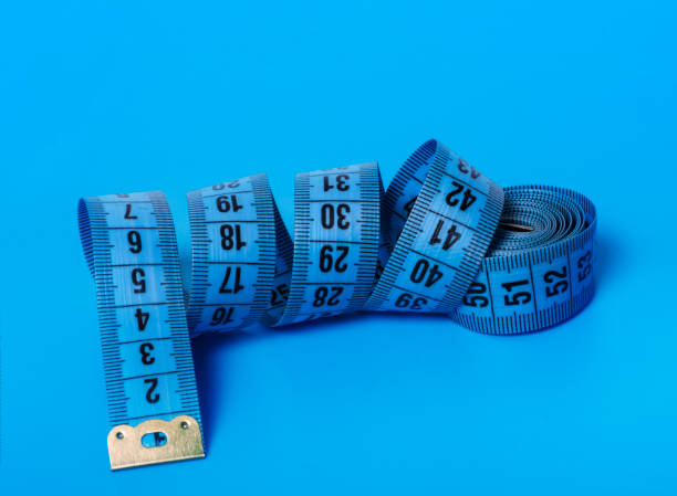 istock untwisted blue measuring tape on a blue background 1282538295
