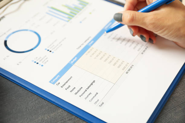 istock Female hand hold pen on black table with business document 1282538815