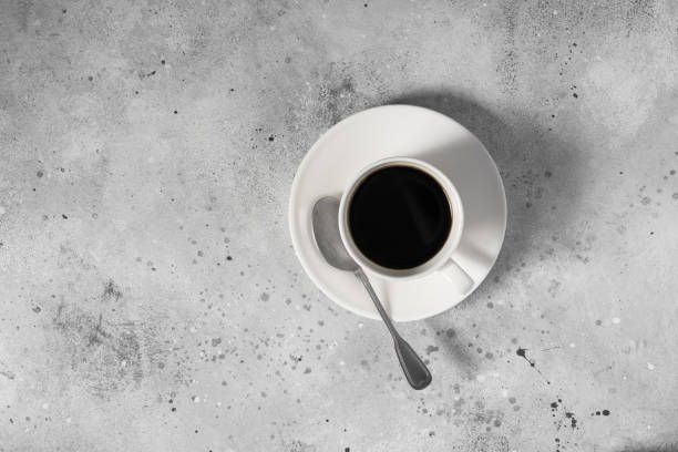 istock A white Cup of coffee on a gray table 1282539644