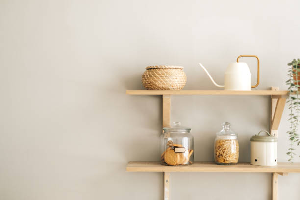 istock Grocery and kitchenware on the wooden shelves in modern bright kitchen. 1282539855
