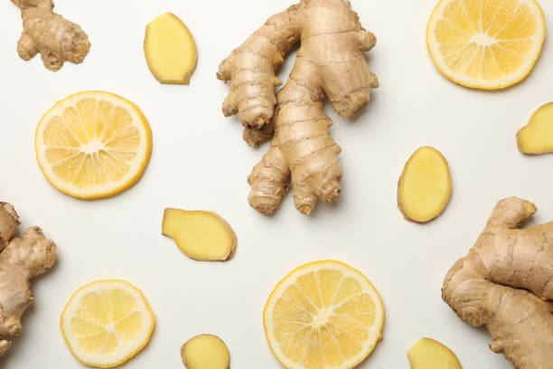 istock Fresh ginger and lemon on white background, top view 1282540348