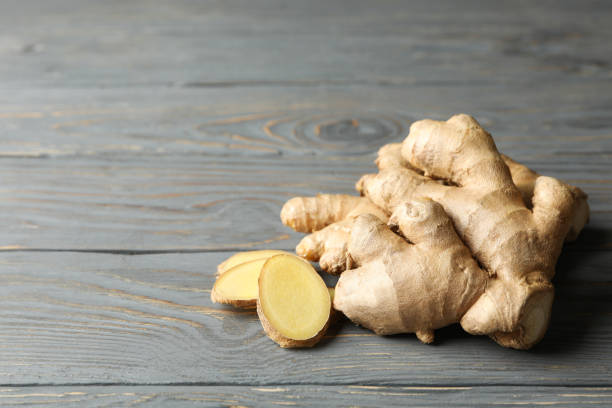 istock Fresh ginger on wooden background, space for text 1282540971